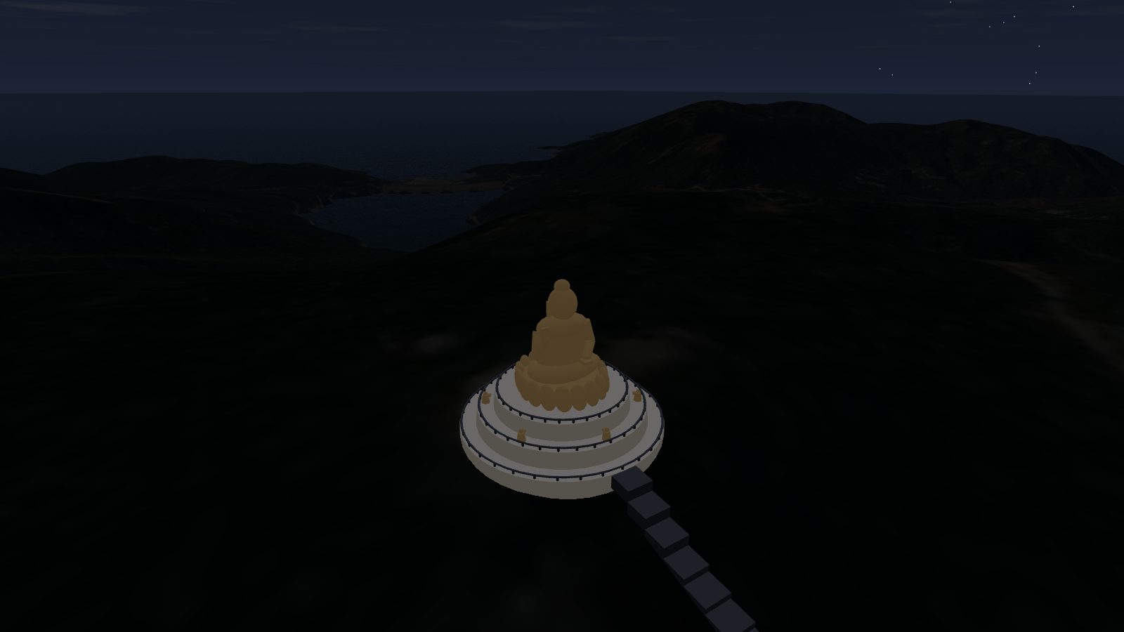 The Big Buddha floodlit in warm light at night on a dark hilltop.