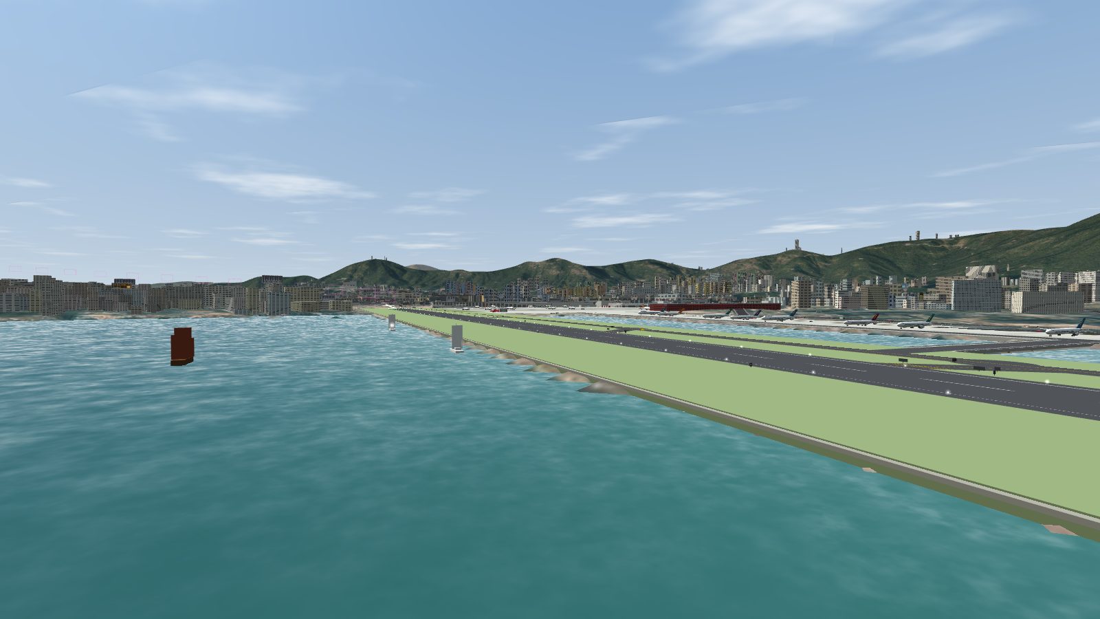A red-sailed junk and yachts on the water beside the Kai Tak runway seawall.