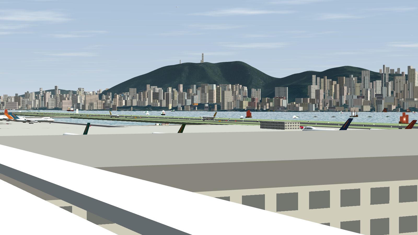The view from the car park roof rail over the terminal roof to the apron, the runway and the harbour.