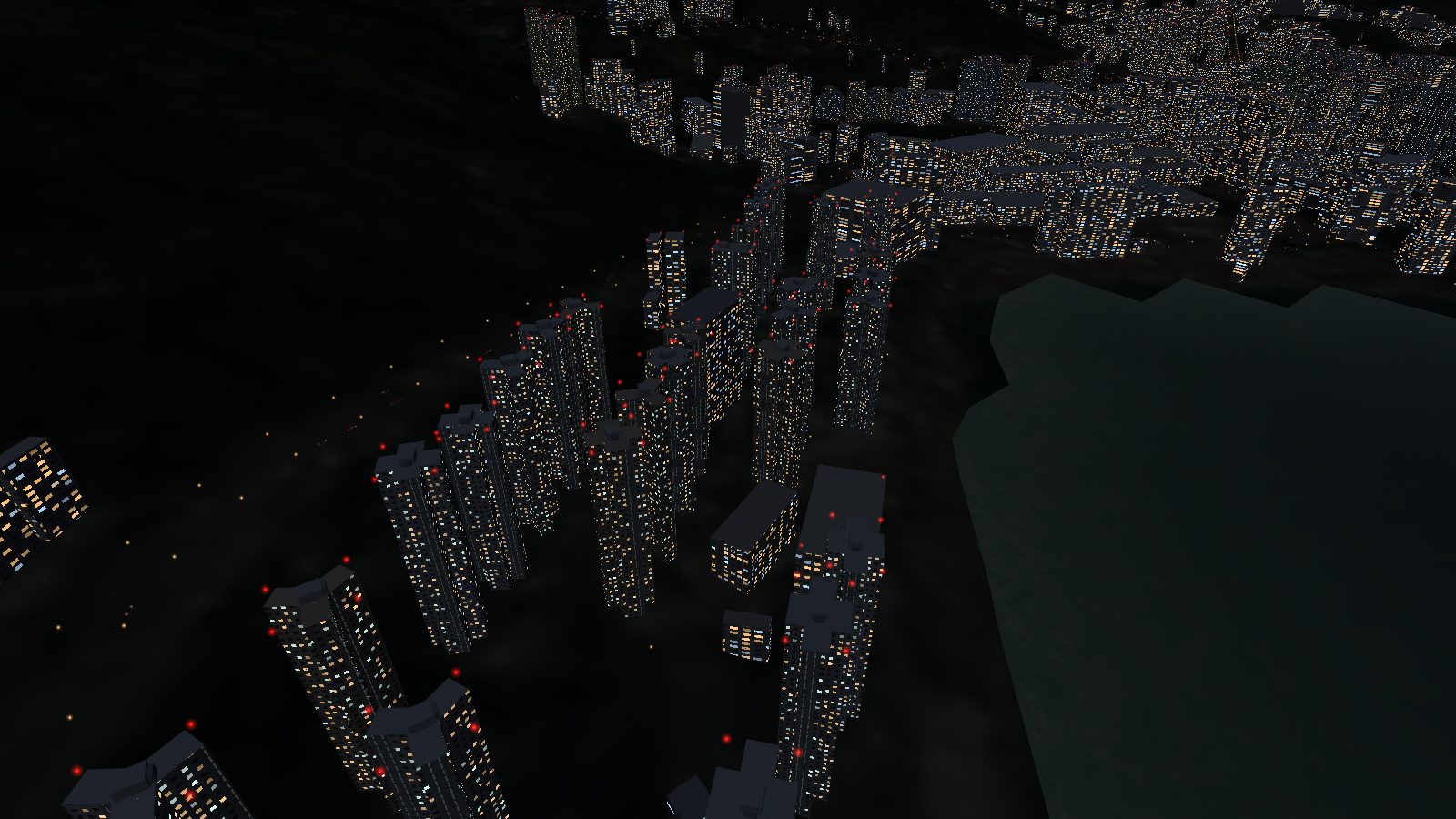 Housing blocks at night with lit windows and red obstruction lights on the roofs, beside dark water.