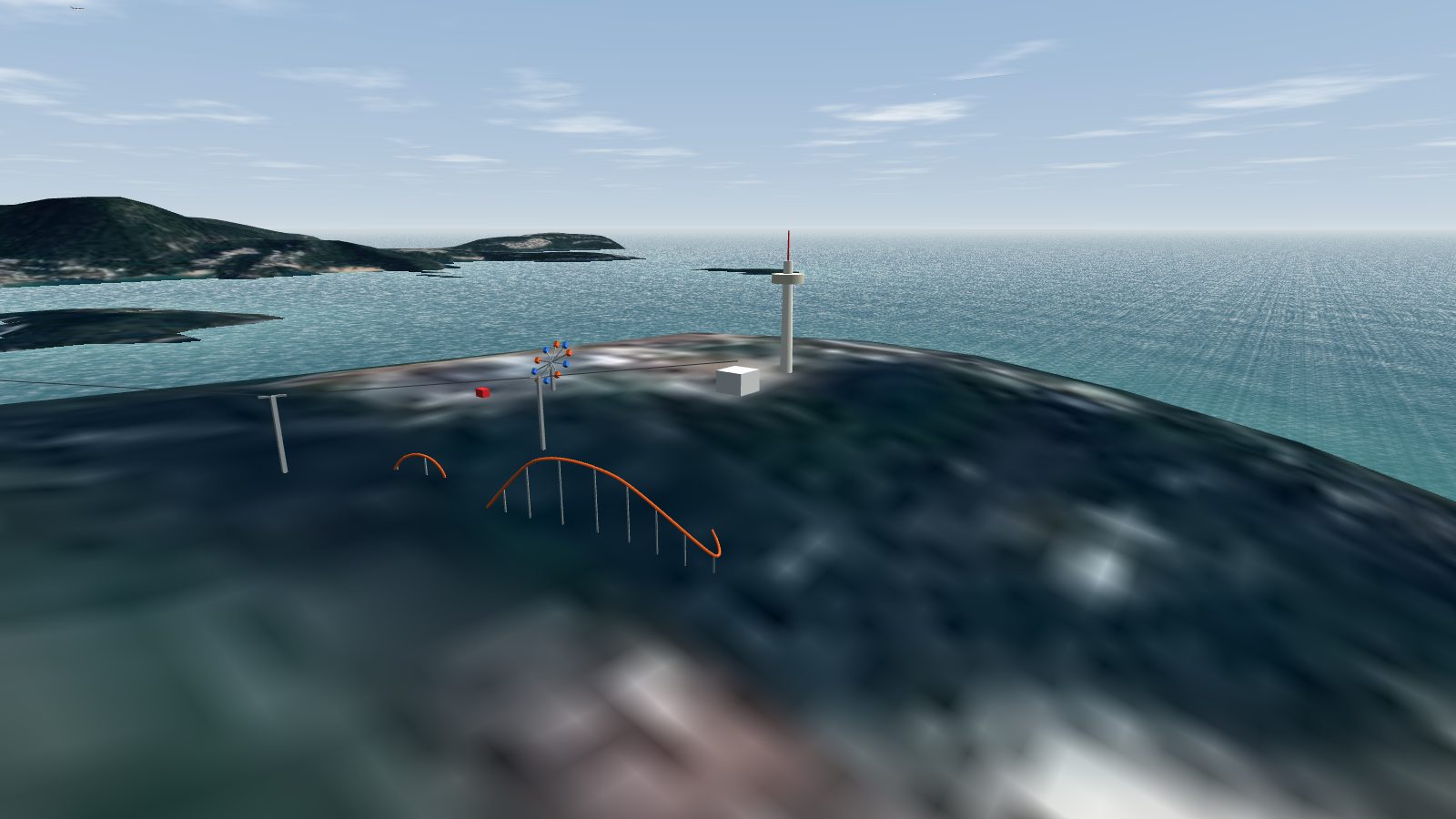 The Ocean Park summit with the tower, a roller coaster, a spinning wheel and the cable car line.