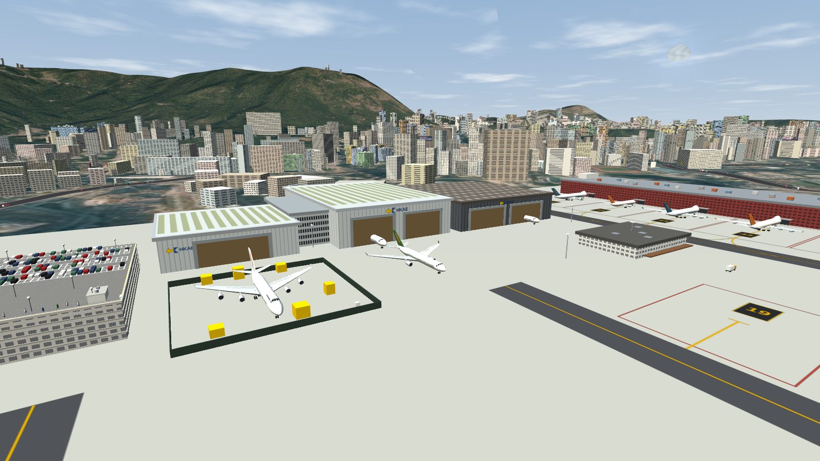 Three hangars with skylight roofs and open door bays beyond a fenced compound with a stripped 747.