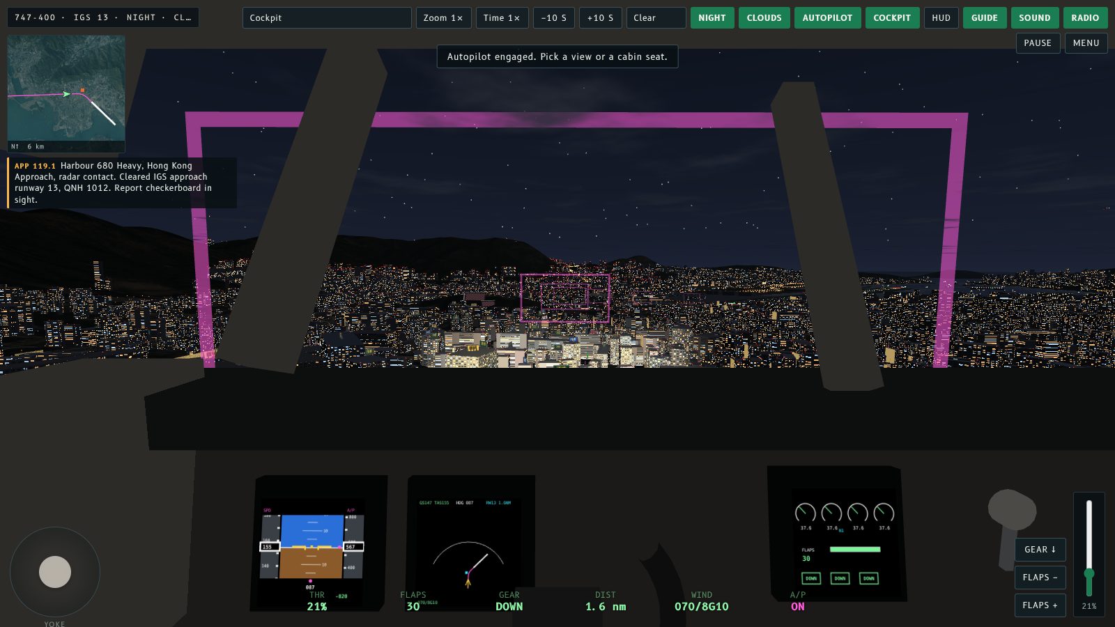 Night cockpit view on the IGS approach with Kowloon's lights spread out ahead.