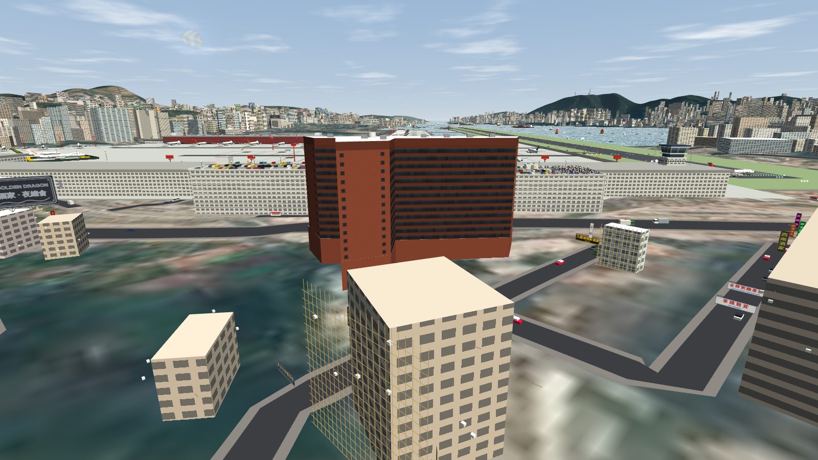 The back of the hotel from Kowloon City, the wing and the long slab forming an L, with the car park, the terminal and the runway beyond.