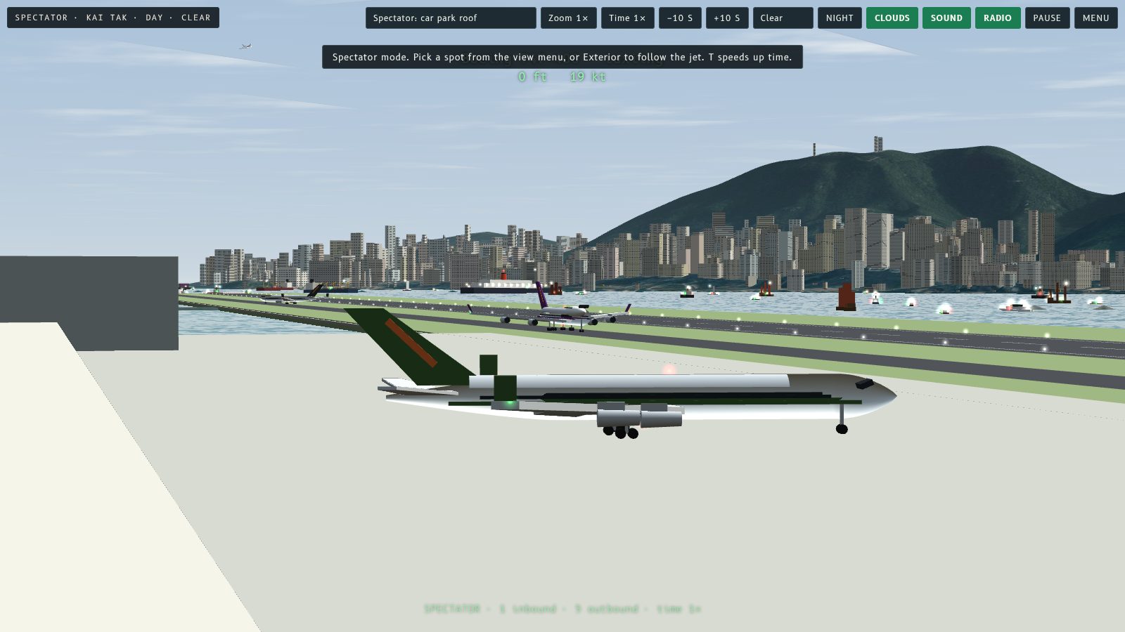 A 747 on the apron at Kai Tak with the runway running out into Victoria Harbour and the Hong Kong skyline behind.
